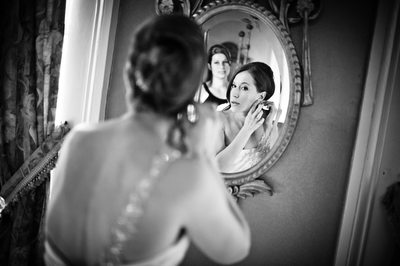 Bride in Mirror Putting On Earrings