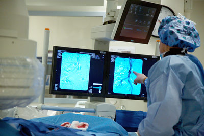 Vascular surgeon examines imaging display