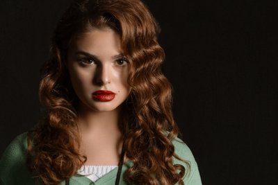 Dramatic portrait of young woman in photography studio