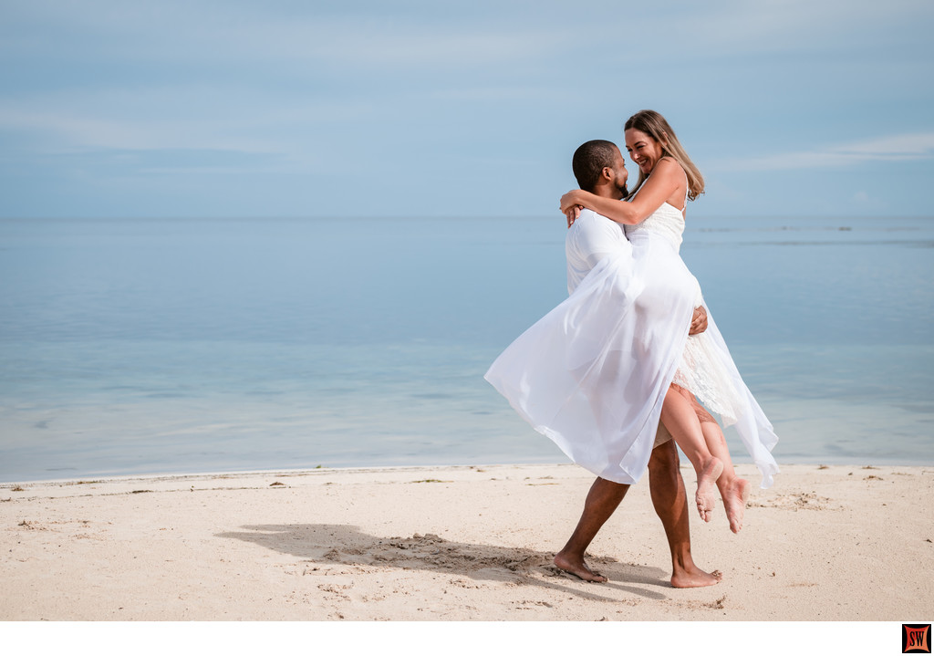 playful beach engagement photo