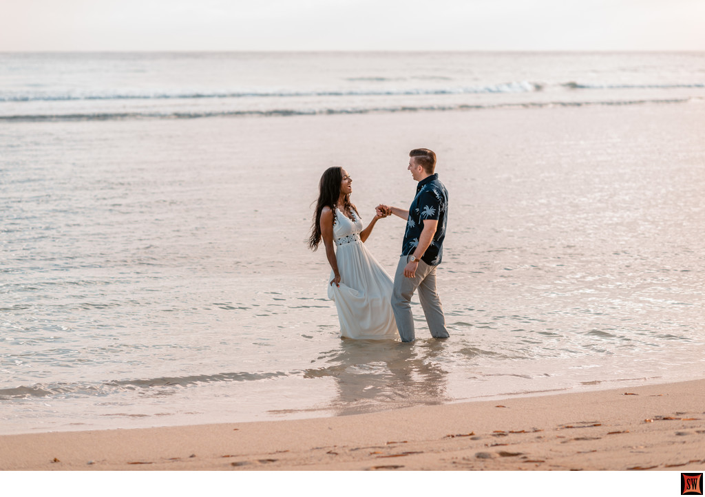 cheerful couple in the shallow water at half moon