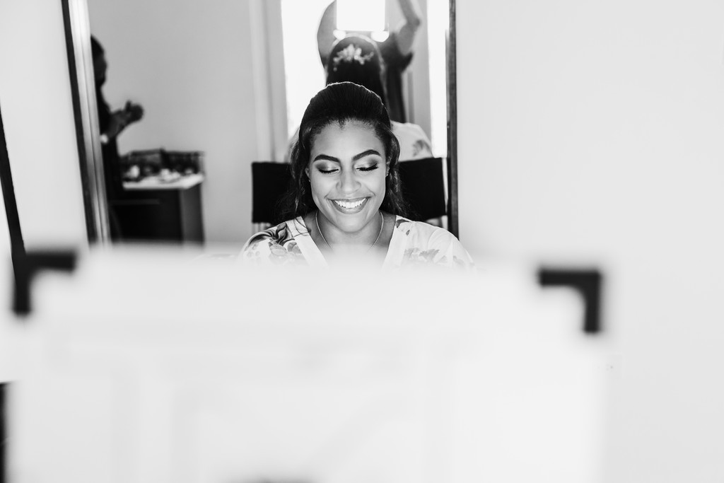 bride admires herself in mirror