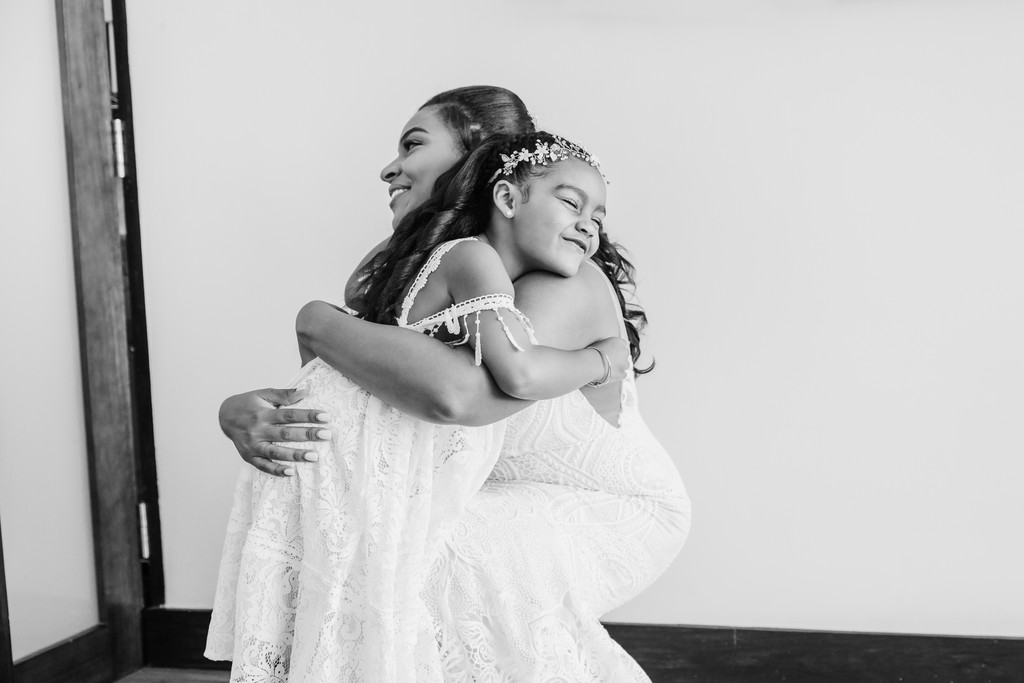 bride and daughter hug at Trident Hotel on wedding day 