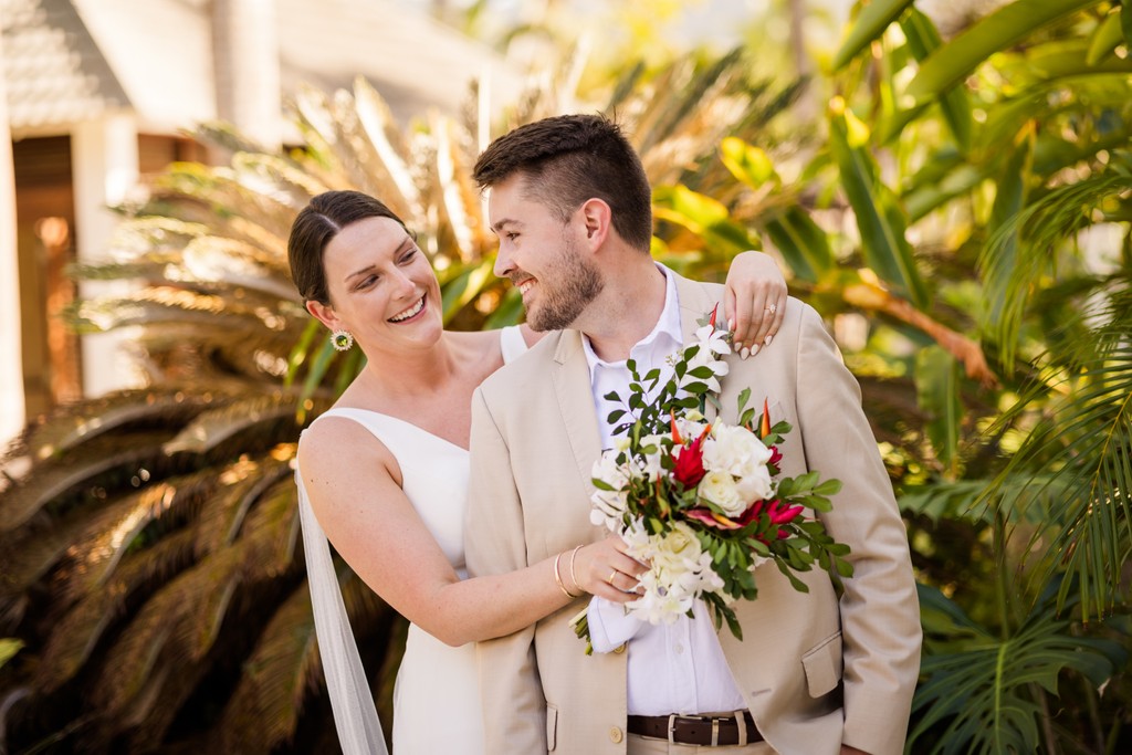 bride hugging groom from behind