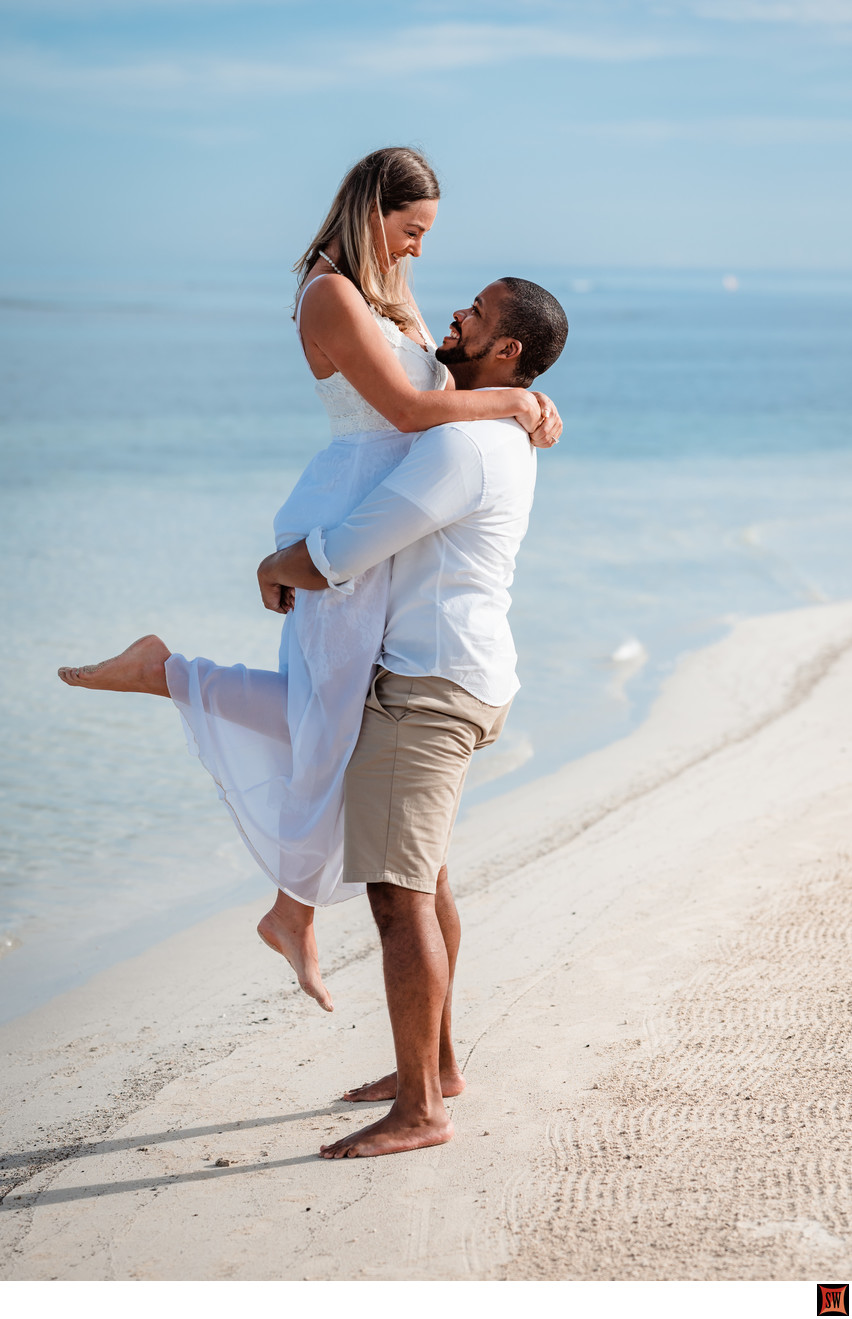 lifted on the beach engagement photo