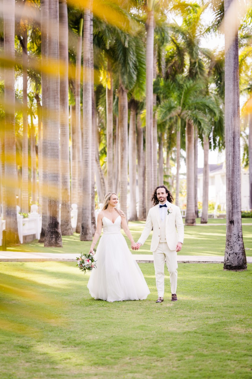 couple surrounded by palm trees in tropical paradise