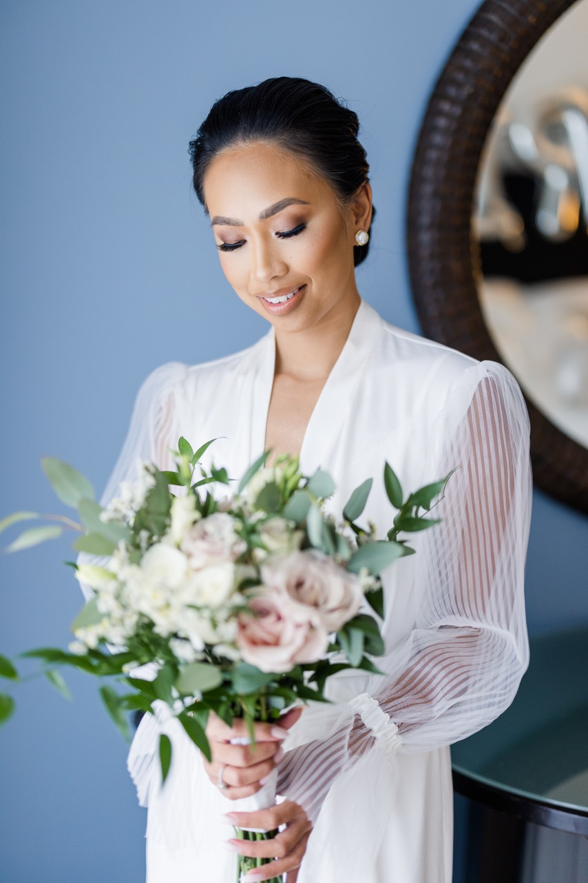 bride admires her flowers getting ready 