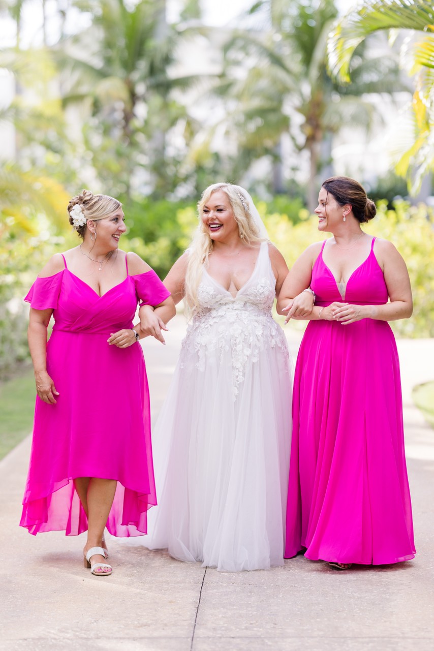 bride with two bridesmaids in pink dresses