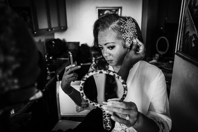 bride getting ready looking at herself in mirror 