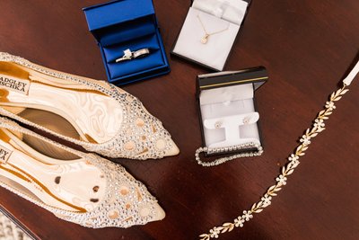 wedding detail of shoes rings, bracelet and necklace