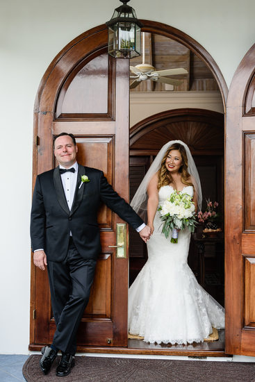 bride and groom holds hands at first look