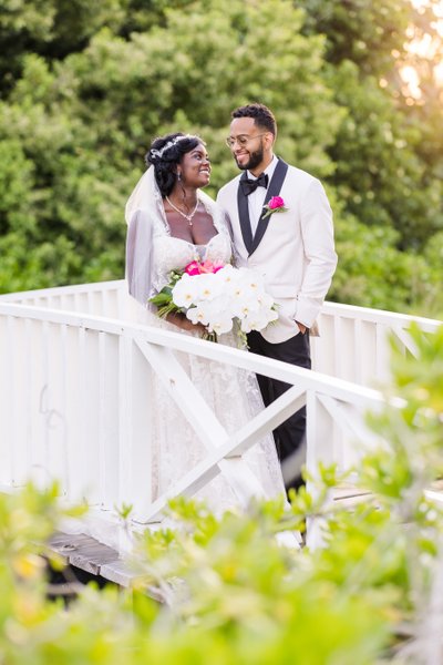 bride and groom on half moon wedding bridge