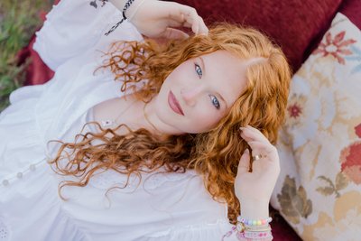 Senior Portrait Close-Up on Vintage Red Sofa