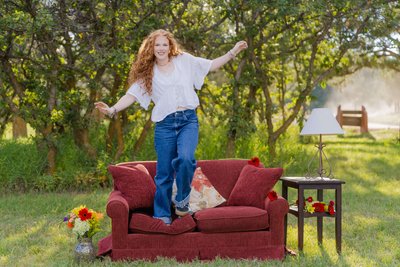 Playful Senior Portrait on Outdoor Vintage Couch