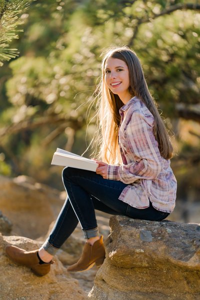 Senior Portrait Reading on Rock Outcrop