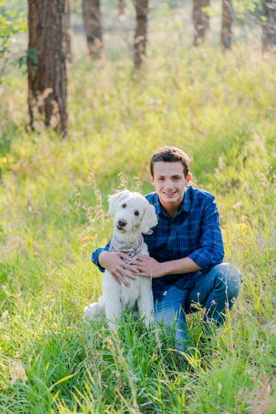 Senior Portrait with Dog in Wooded Field