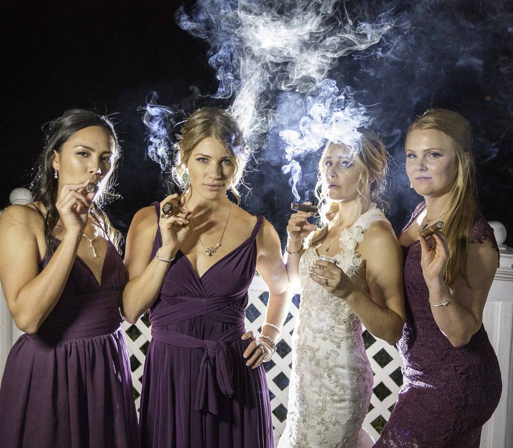 Bridesmaids smoking a cigar