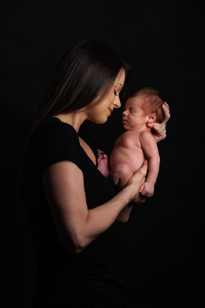 Romantic Maternity Couple Portrait with a Pink Studio Backdrop in Dublin, California