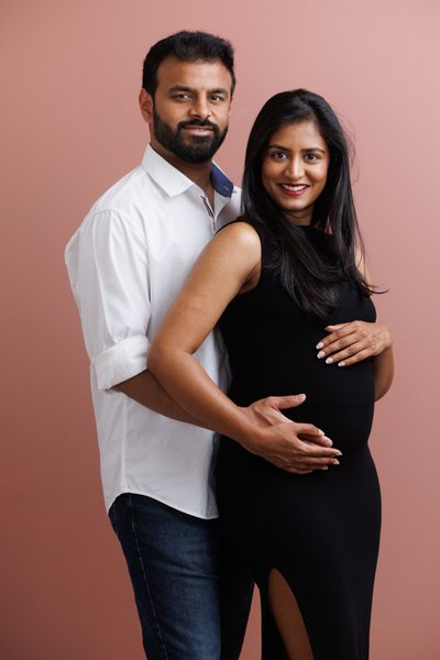Romantic Maternity Couple Portrait with a Pink Studio Backdrop in Dublin, California