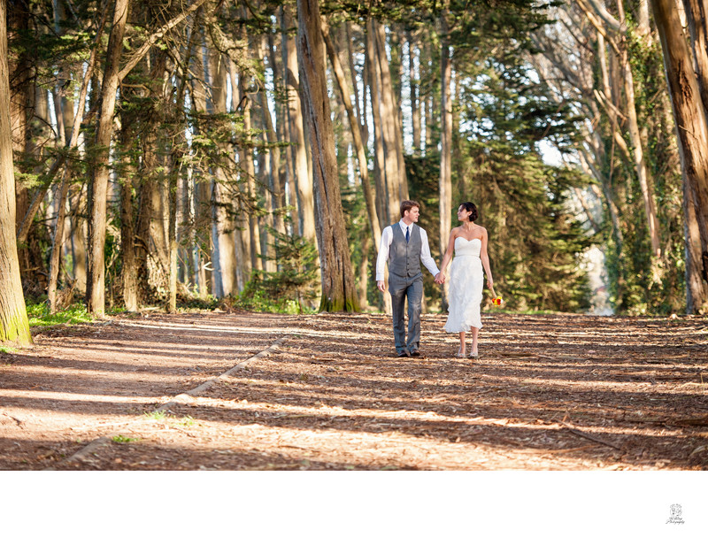 A couple hand in hand in the Presidio after Elopement CIty Hall