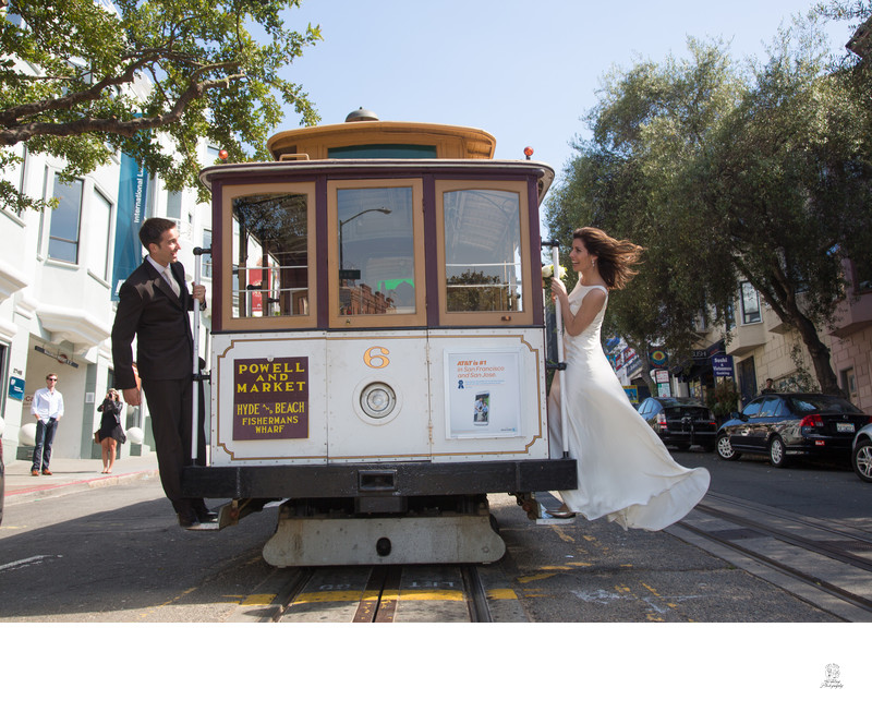 San Francisco City Hall Wedding Photographer - Couple on cable car dress flowing
