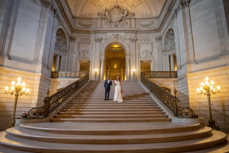 sf city hall wedding photos - couple walking down the Grand Staircase after nuptials by San Francisco City Hall Wedding Photographer | Love & Lavender
