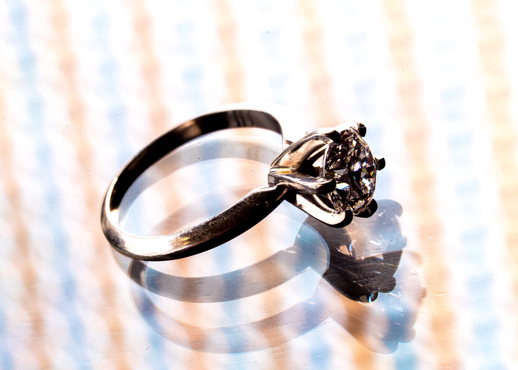 Sparkling Diamond Ring on Reflective Surface