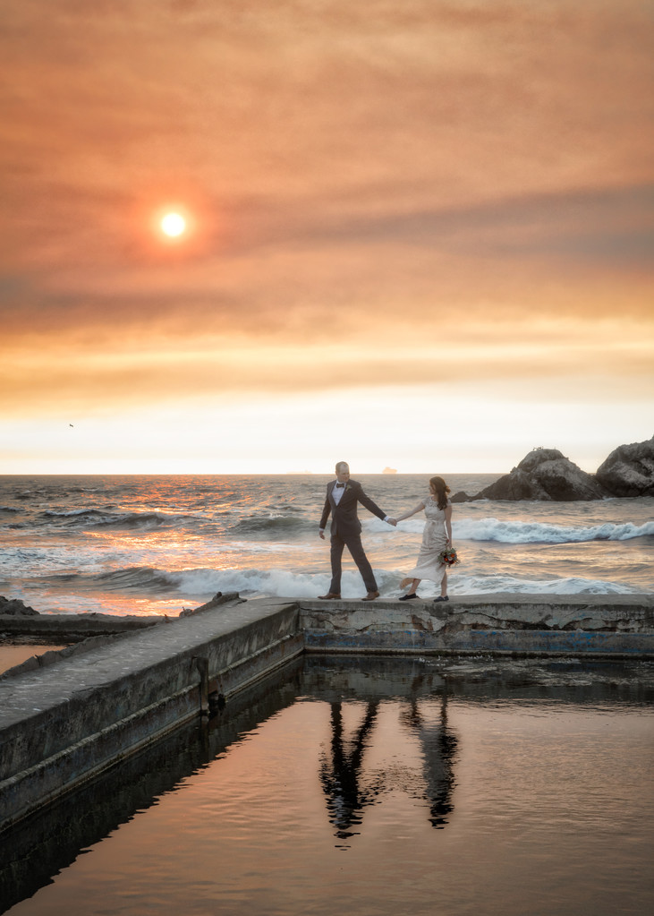 Sutro Baths Sunset: Couple's hold hands in Reflection