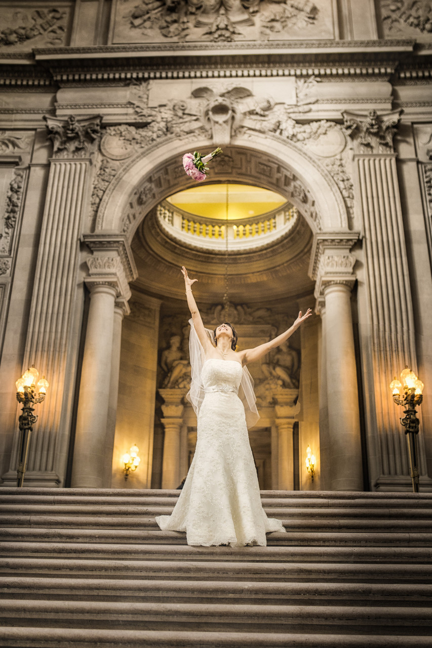 bride with bouquet top of grand staircase