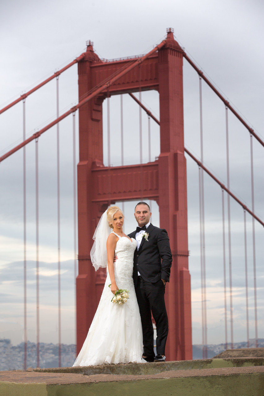 Newlyweds & Golden Gate Bridge: Elegant Pose, Under Dramatic Sky