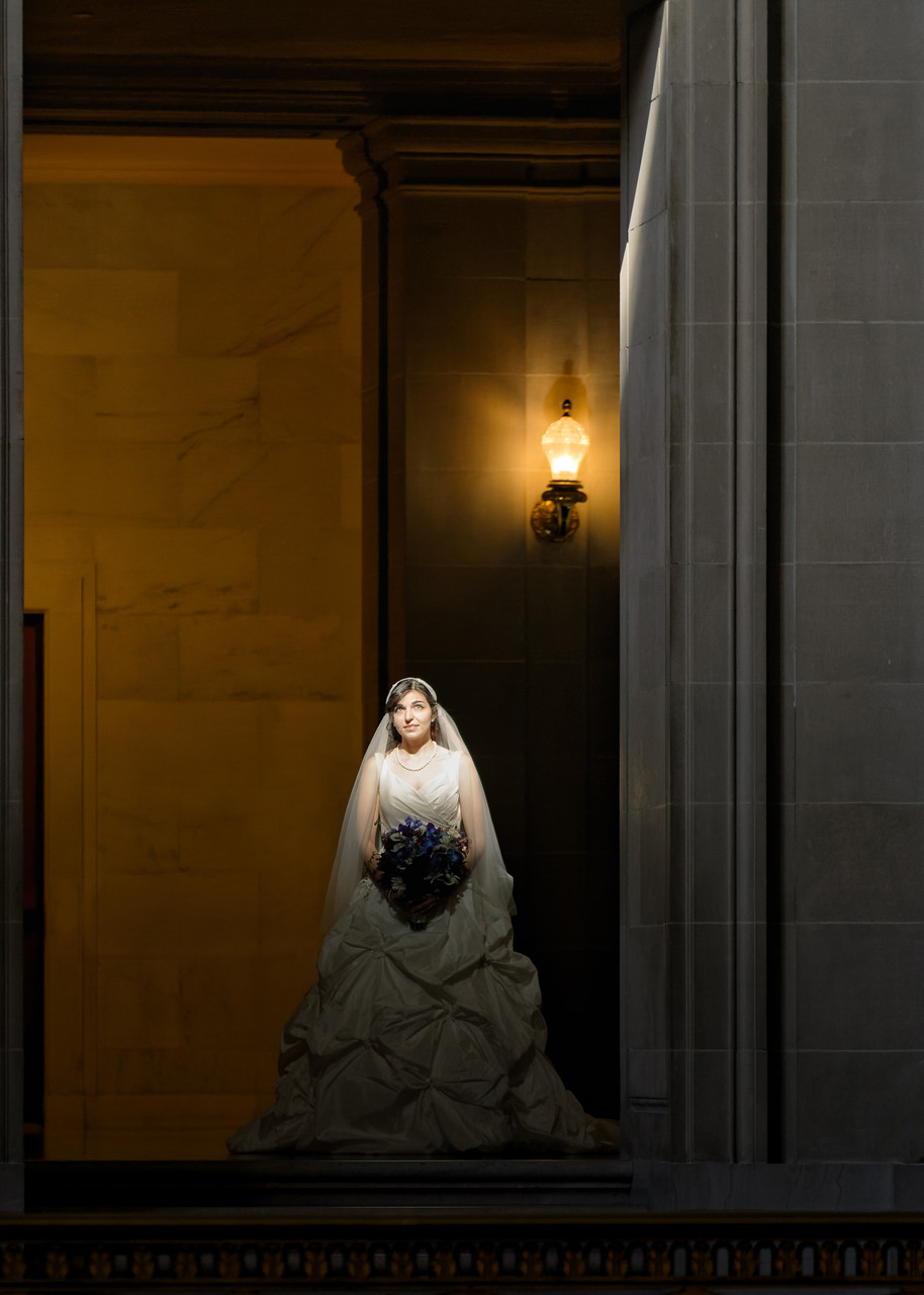 Window light touches bride from dome