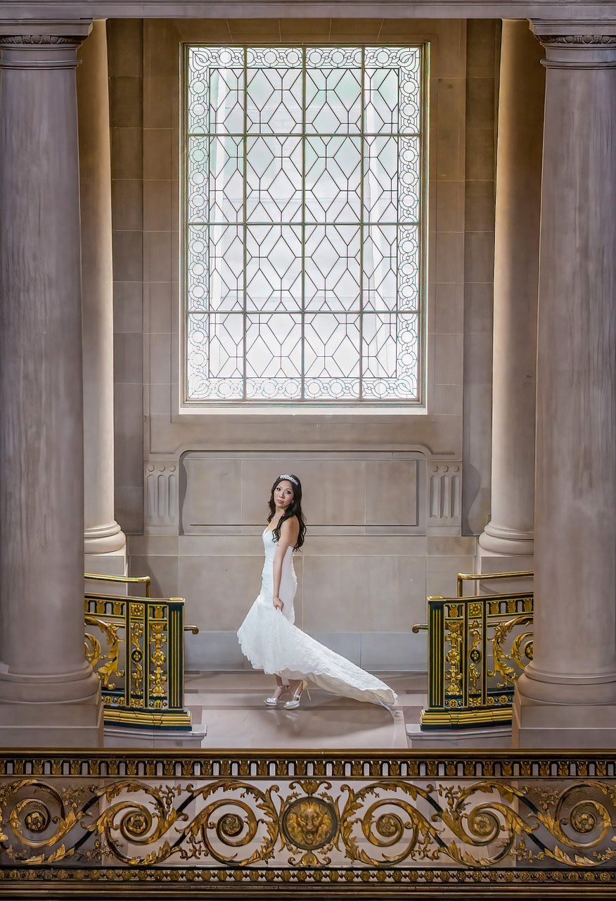 Elegant slender Chinese bride spinning her gorgeous dress | San Francisco City Hall Wedding Photographer
