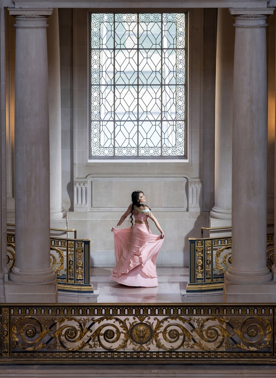 Elegant Woman in Pink Gown Amongst Marble Columns