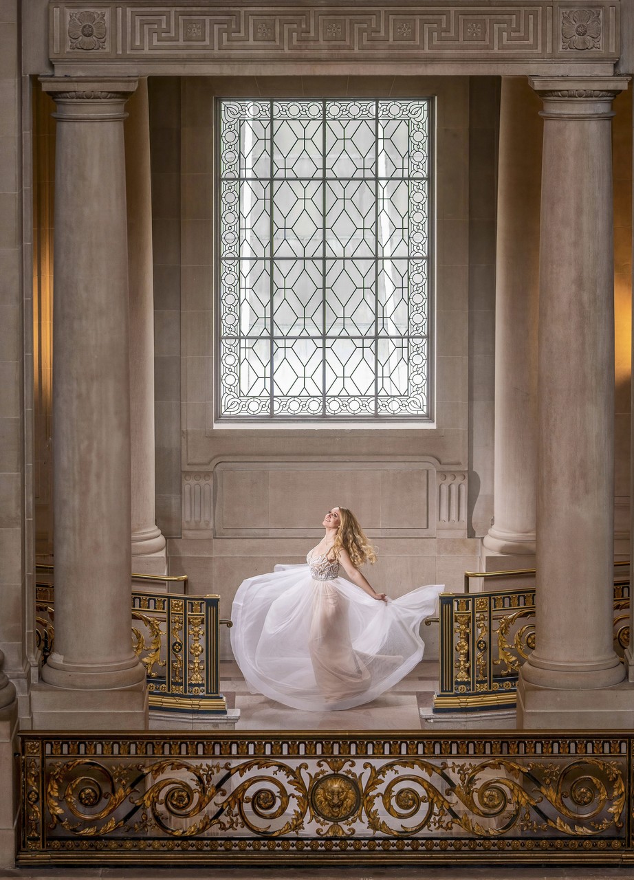 Bride's Elegant Staircase Descent by Grand Window