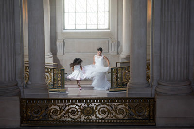 Bride and daughter twirling  together SF City Hall.
