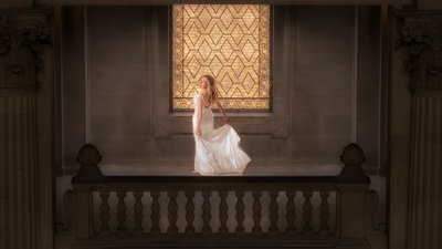 Elegant Bride on Ornate Balcony with Stained Glass