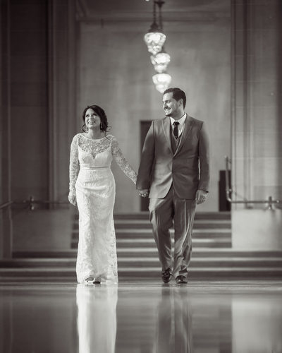 groom walking with bride 2nd floor candid loving moment