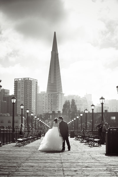 Newlyweds Embrace on San Fran Pier 7 with Transamerica Tower