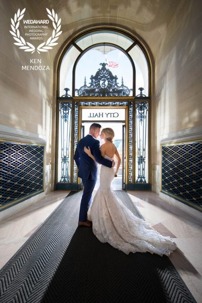 Dramatic Backlit San Francisco City Hall Wedding Exit with an Embrace