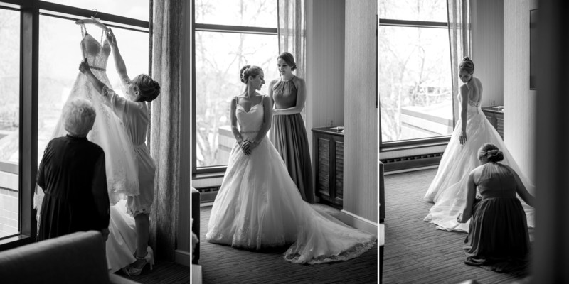 Bride putting on wedding dress in getting ready room