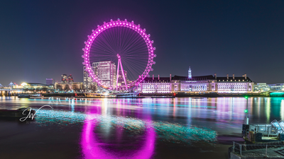 London Eye with light trails from a passing boat