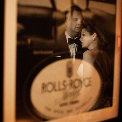 bride and groom reflected in a vintage picture frame at the Aviator Hotel in Farnborough