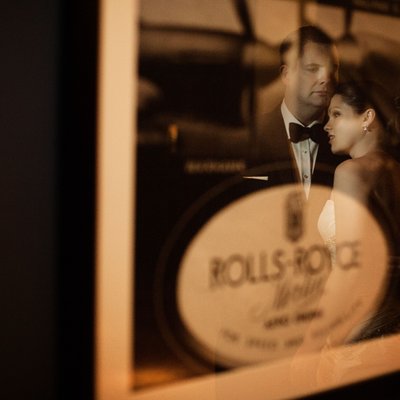 bride and groom reflected in a vintage picture frame at the Aviator Hotel in Farnborough