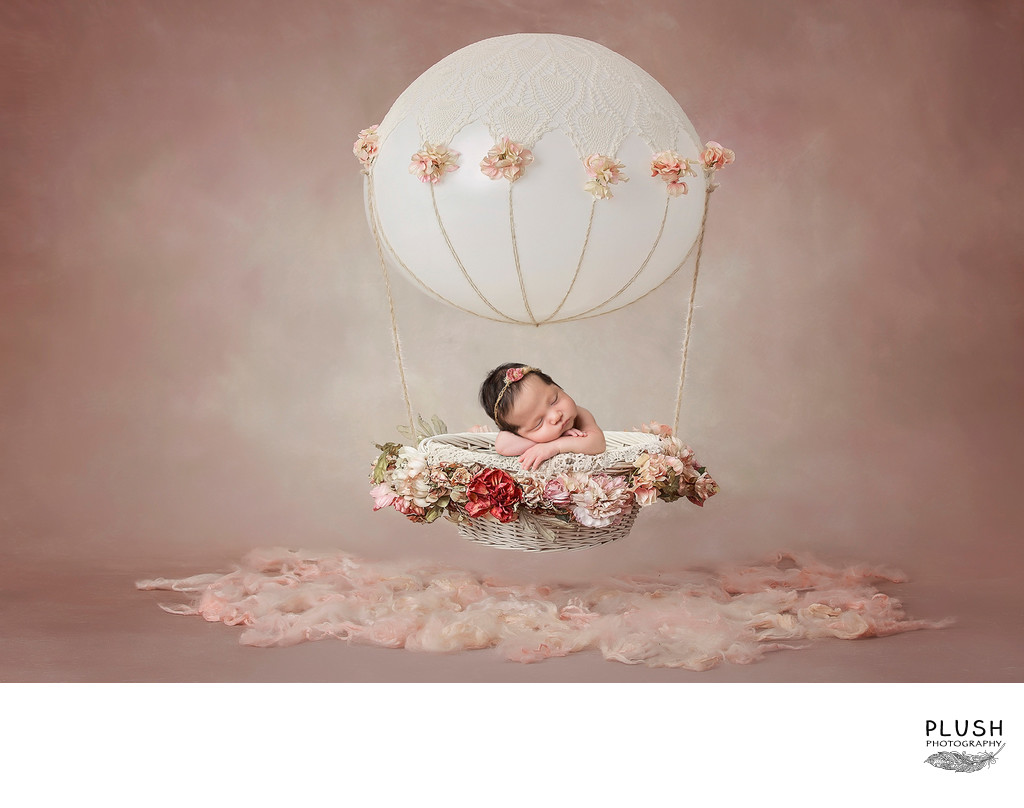 Newborn girl in hot air balloon