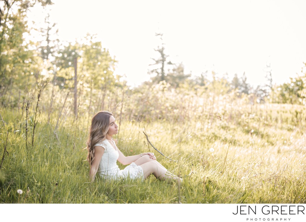 High school senior in a sunlit field in Portland.