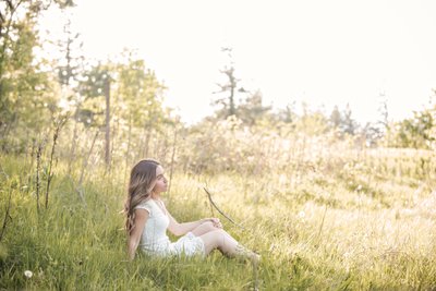 High school senior in a sunlit field in Portland.