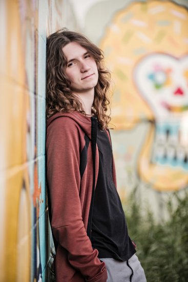 Senior with graffiti wall