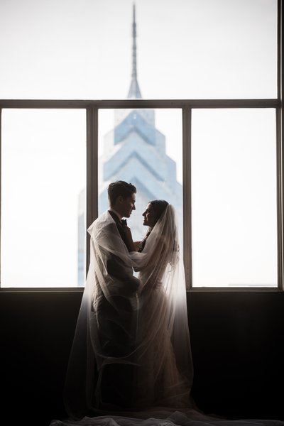 Bride and Groom in Loews Overlooking One Liberty Place