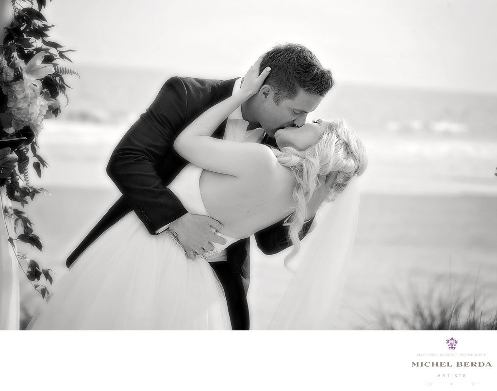 The wedding kiss at wedding ceremony at Sea Side Point Wild Dunes Resort