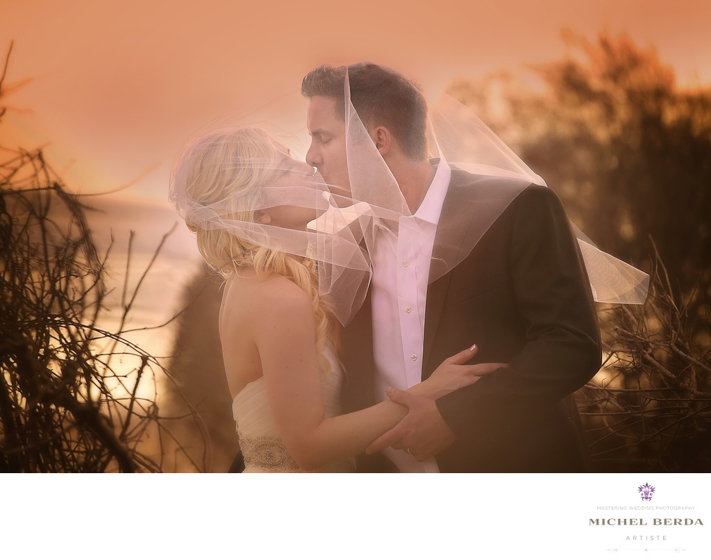 Bride And Groom Sunset kiss on the beach wedding ceremony Wild Dunes Resort